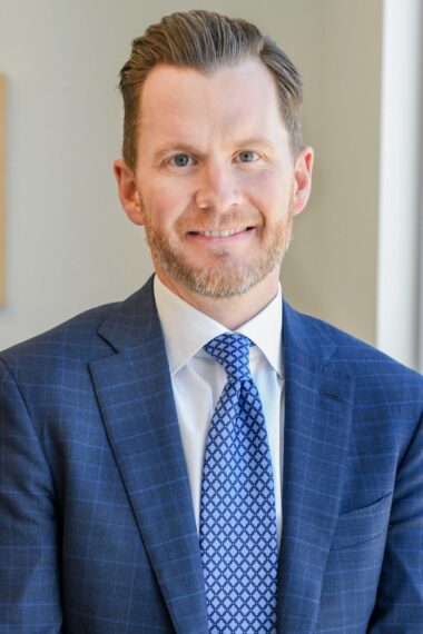 Corporate headshot of Evan Carruthers